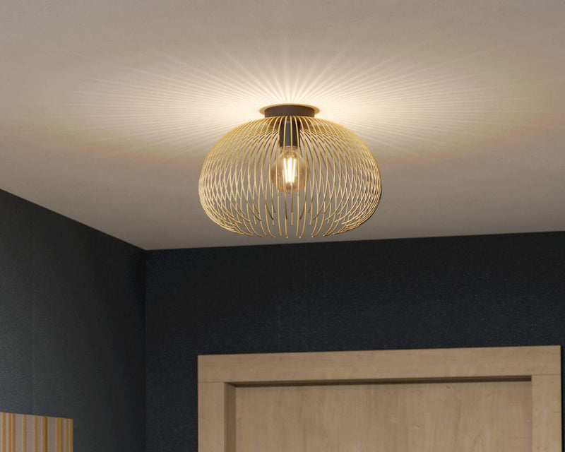 Gold wire mesh dome semi-flush ceiling light casting geometric shadow pattern on ceiling in dark navy interior