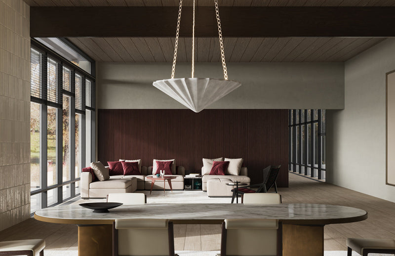 Large white pleated fabric cone pendant on brass chain over oval marble dining table in contemporary open-plan living space
